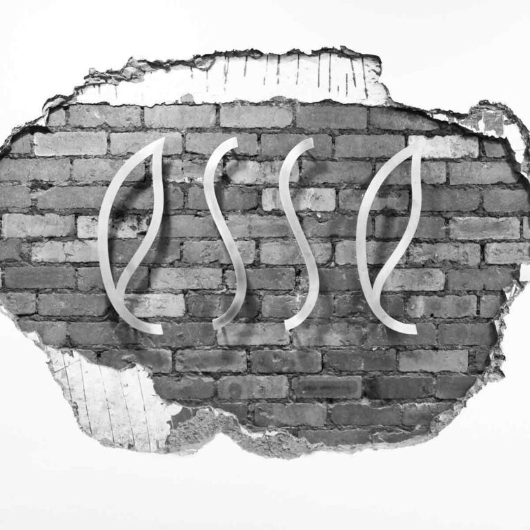 Office Conversions: Esse logo mounted on exposed brickwork interior detail.